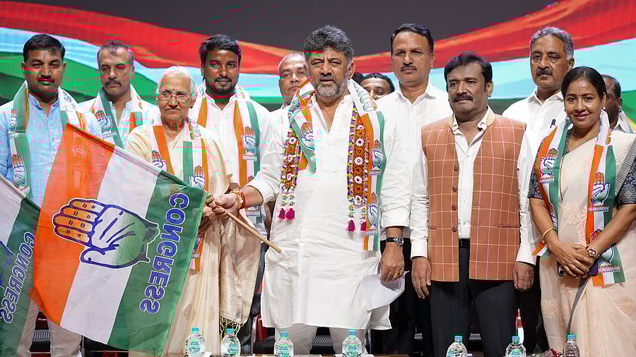 <div class="paragraphs"><p>Deputy Chief Minister and Karnataka Pradesh Congress Committee president&nbsp;D K Shivakumar hands over the party flag to former state minister B T Lalitha Naik as the latter joins Congress during an event, in Bengaluru on Friday. </p></div>