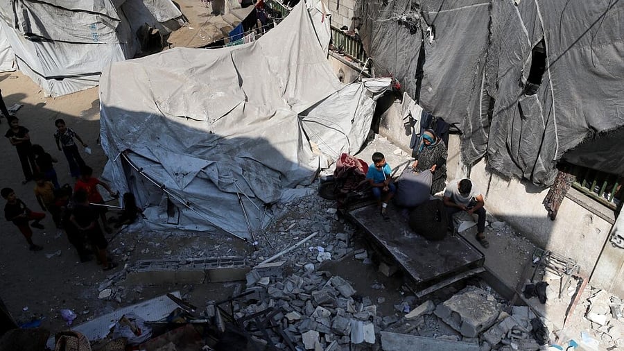 <div class="paragraphs"><p>Palestinians inspect the damage following an overnight Israeli strike on a school sheltering displaced families, in Jabalia</p></div>