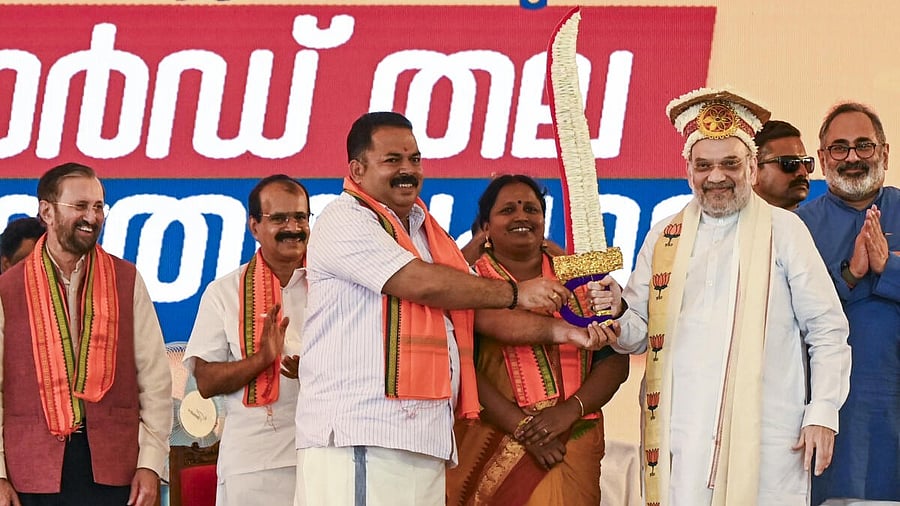 <div class="paragraphs"><p>Union Home Minister Amit Shah being felicitated during a public meeting, in Thiruvananthapuram, Saturday, July 12, 2025. Kerala BJP President Rajeev Chandrasekhar is also seen.</p></div>