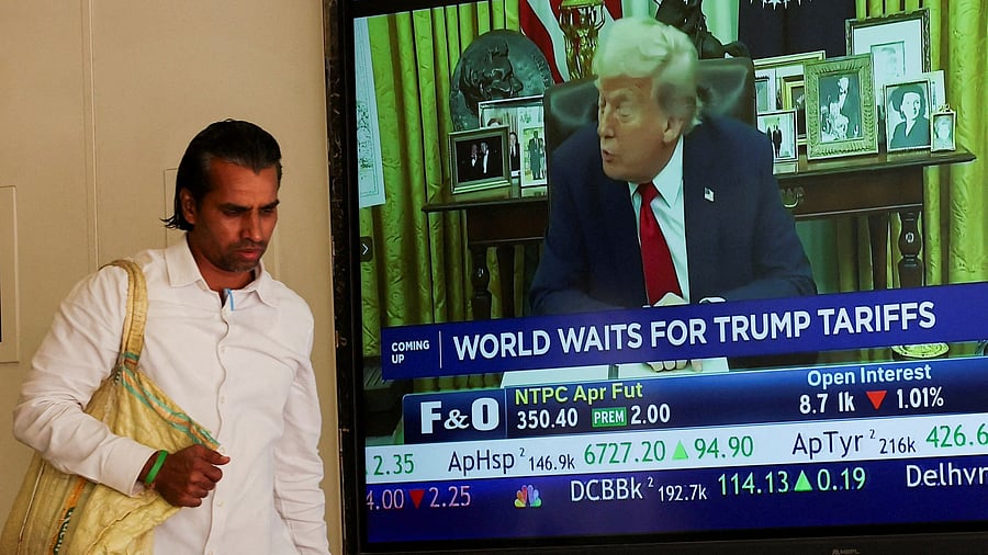 <div class="paragraphs"><p>A man walks past a screen displaying US President Donald Trump, at the Bombay Stock Exchange (BSE) ahead of Trump's tariff plans, in Mumbai.</p></div>