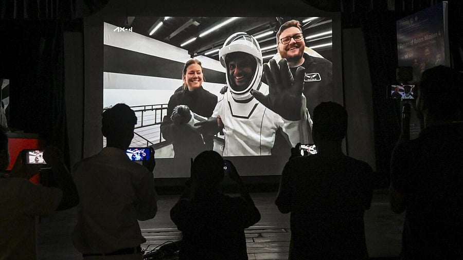 <div class="paragraphs"><p>People watch the live screening of the Dragon "Grace" capsule's splashdown off the coast of San Diego in California, in Kolkata, Tuesday, July 15, 2025.</p></div>