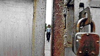 <div class="paragraphs"><p>A security guard on patrol inside the closed premises of  Hindustan Motors' plant.</p></div>