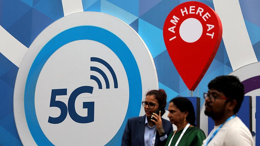 <div class="paragraphs"><p>People stand in front of a board depicting 5G network.</p></div>