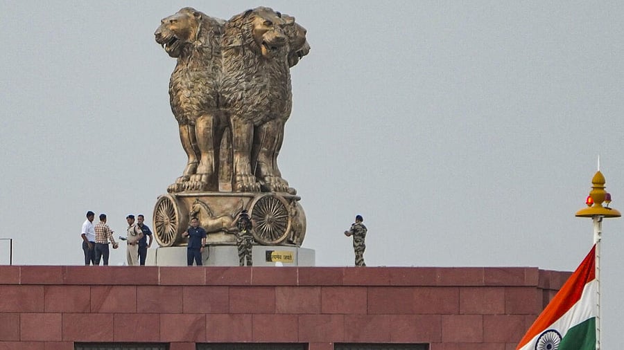 <div class="paragraphs"><p>Security personnel atop the Parliament building in New Delhi.&nbsp;</p></div>
