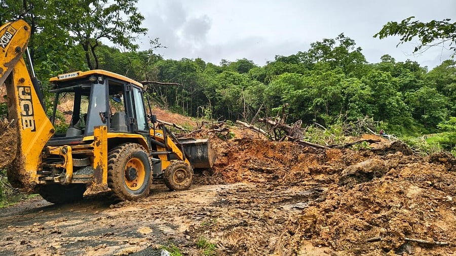 <div class="paragraphs"><p>An earth moving machine deployed by KPLC clears the debris on Kadra-Kodasalli road on Wednesday. </p></div>