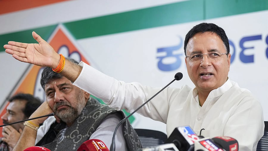 <div class="paragraphs"><p>Deputy Chief Minister looks on as AICC General Secretary in-charge of Karnataka Randeep Singh Surjewala addresses a press conference.</p></div>