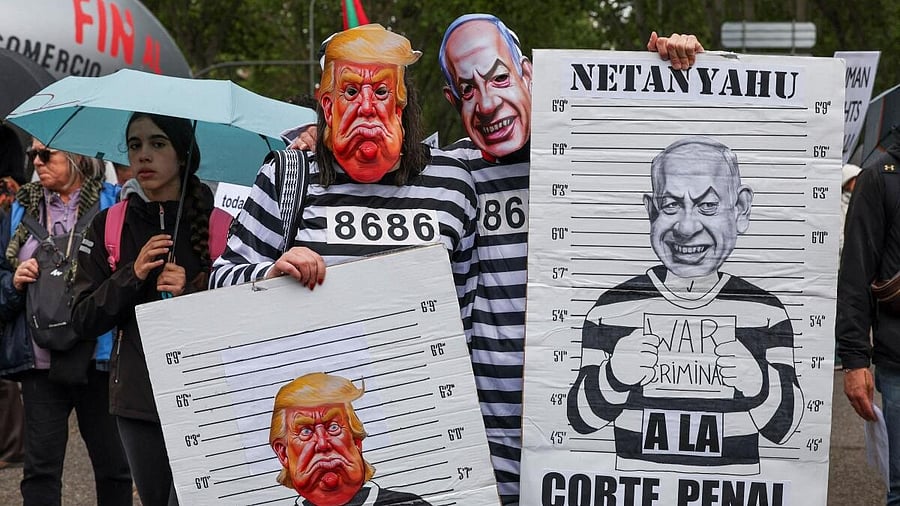 <div class="paragraphs"><p>People wear masks depicting U.S. President Donald Trump and Israeli Prime Minister Benjamin Netanyahu during a demonstration in solidarity with Palestinians calling for a halt in arms trade and relations with Israel, in Madrid.</p></div>
