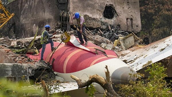 <div class="paragraphs"><p>Wreckage of the crashed Air India plane, which crashed into a medical hostel and its canteen complex moments after taking off from the Sardar Vallabhbhai Patel International Airport, being lifted through a crane, in Ahmedabad.</p></div>