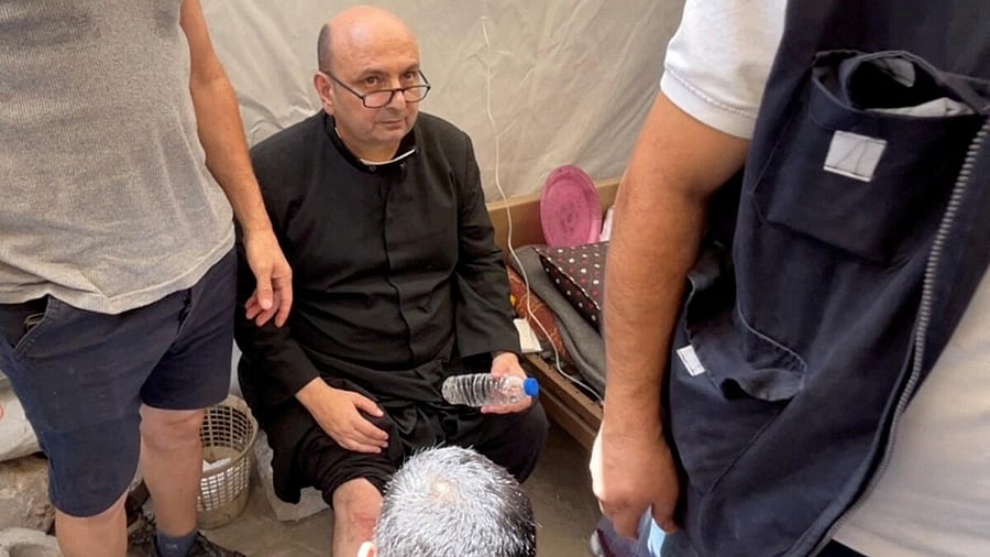 <div class="paragraphs"><p>Parish priest of the Church of the Holy Family, father Gabriele Romanelli, receives medical attention, after he suffered light leg injuries following an Israeli strike on the church, according to medics, at Al-Ahli Arab Hospital in Gaza City.</p></div>
