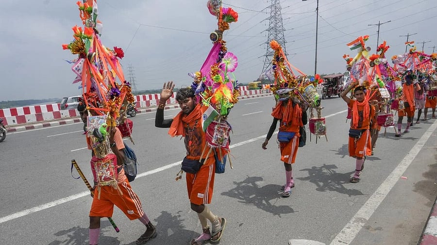 <div class="paragraphs"><p>‘Kanwariyas’ walk along a road during the annual ‘Kanwar Yatra’ in the holy month of ‘Shravan’. </p></div>