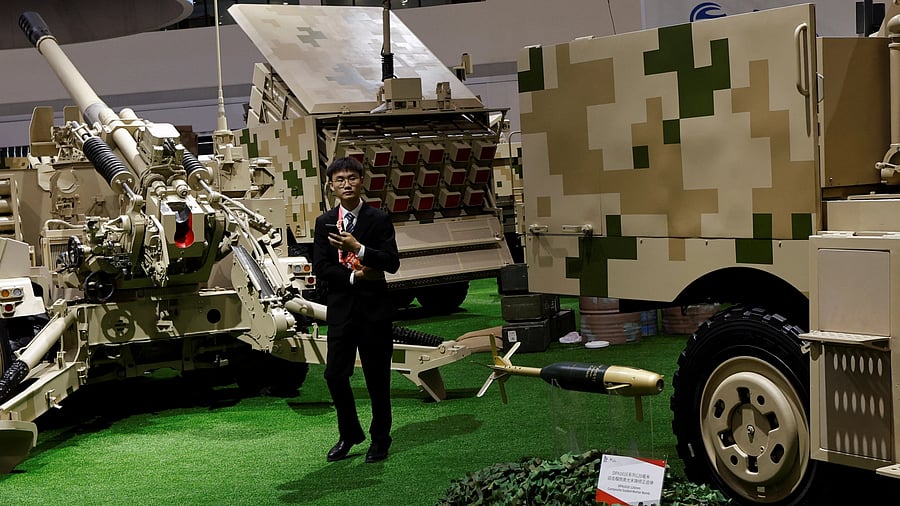 <div class="paragraphs"><p>A man stands amid weapon displays at the Norinco booth during the China International Aviation and Aerospace Exhibition, or Airshow China, in Zhuhai, Guangdong province, China </p></div>