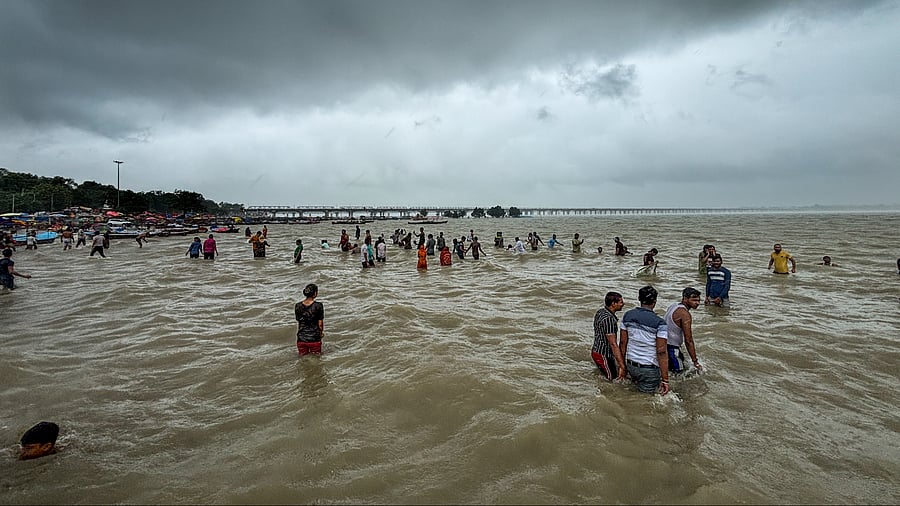 <div class="paragraphs"><p>Devotees take holy dip in the swollen River Ganga amid rainfall, in Prayagraj, Thursday, July 17, 2025.</p></div>