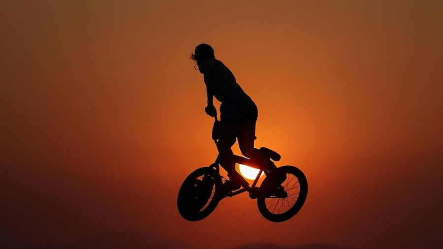 <div class="paragraphs"><p>A biker performs tricks at Kavouri beach on a hot day near Athens</p><p></p></div>