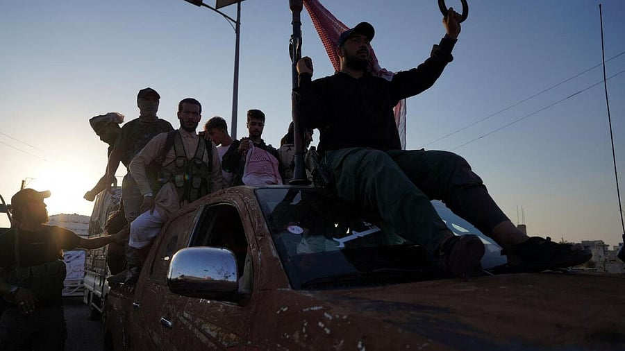 <div class="paragraphs"><p>Bedouin fighters ride a truck in the village of Al-Mazraa, after days of violence in the Sweida province sparked by clashes between Bedouin fighters and Druze factions, in Sweida, Syria.</p></div>