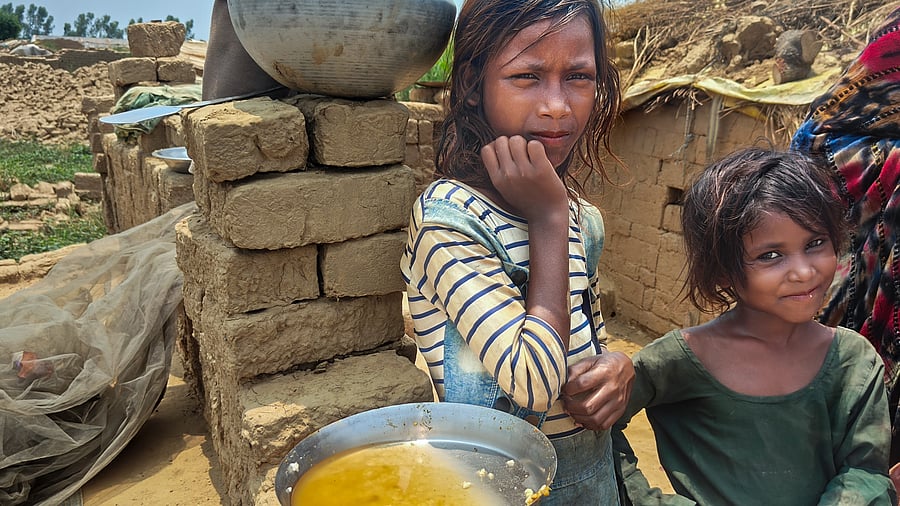 <div class="paragraphs"><p>Children who work with their families at a brick kiln, in Aligarh district, Uttar Pradesh, Wednesday, May 28, 2025. </p></div>