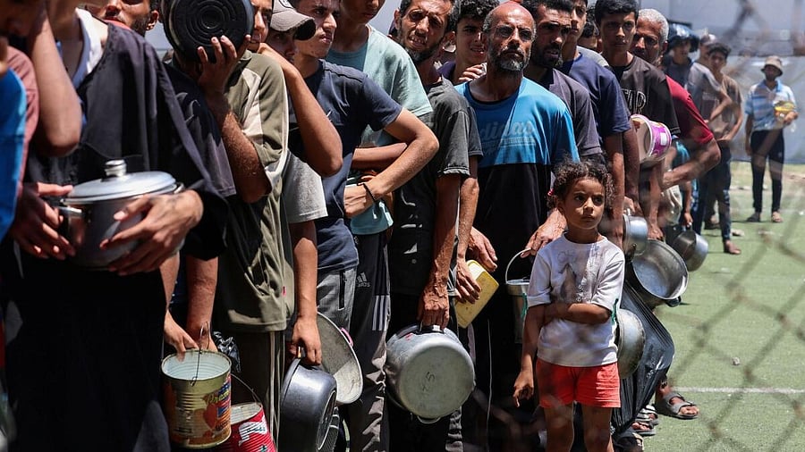 <div class="paragraphs"><p>Palestinians gather to receive food from a charity kitchen, amid a hunger crisis, in Nuseirat, central Gaza Strip.</p></div>