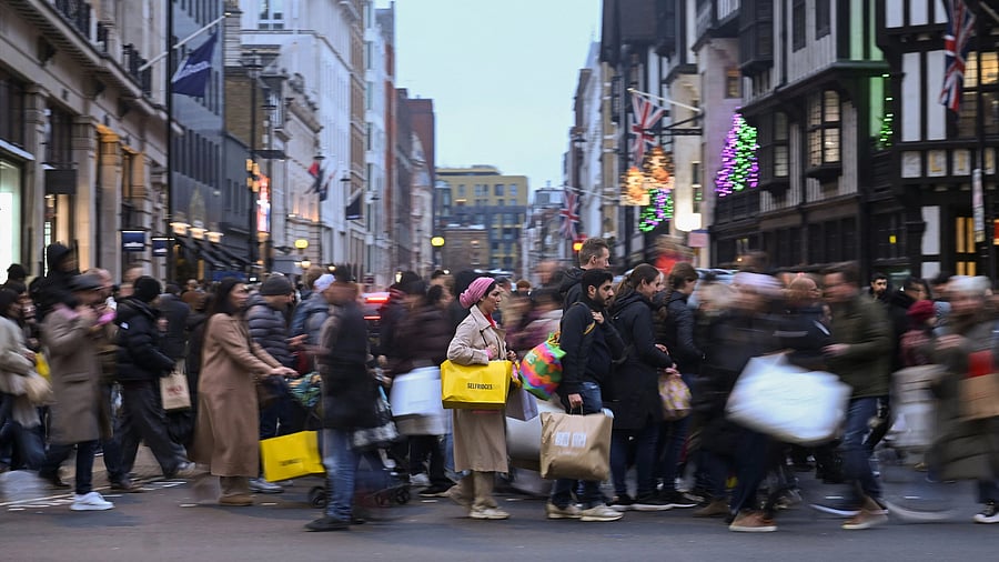 <div class="paragraphs"><p>Shoppers cross the street on Regent St during Boxing Day sales, in London, Britain, </p></div>
