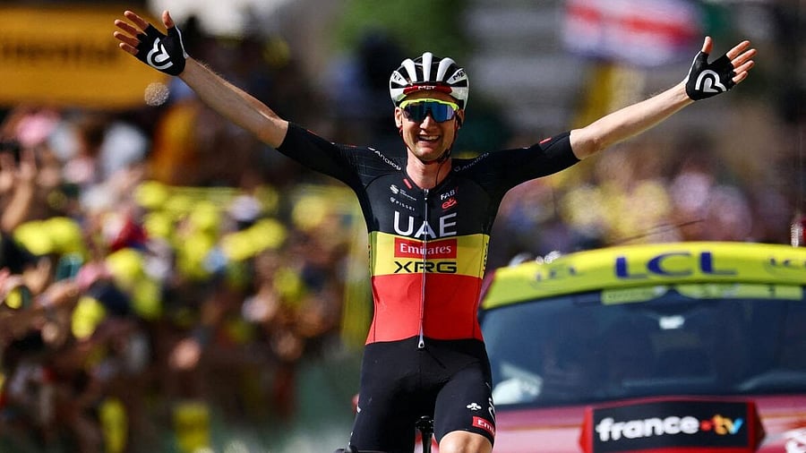 <div class="paragraphs"><p>Team Emirates XRG's Tim Wellens celebrates as he crosses the finish line to win stage 15.</p></div>