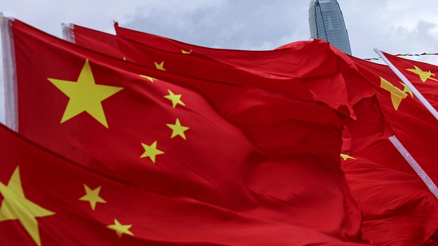 <div class="paragraphs"><p>Chinese flags flutter in front of Two International Finance Centre  during an event.</p></div>