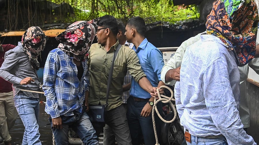 <div class="paragraphs"><p>Three of the four accused, arrested in the murder of gangster Chandan Mishra inside a private hospital in Patna, being brought to a court with their heads covered, in Kolkata, West Bengal, Sunday, July 20, 2025. Mishra, a resident of Buxar district, who was a murder convict and out on parole, was shot dead by gunmen inside a private hospital in Patna on Thursday morning.</p></div>