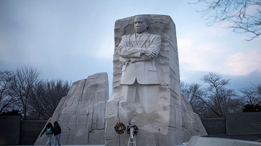 <div class="paragraphs"><p>People walk by the Martin Luther King, Jr. Memorial</p></div>