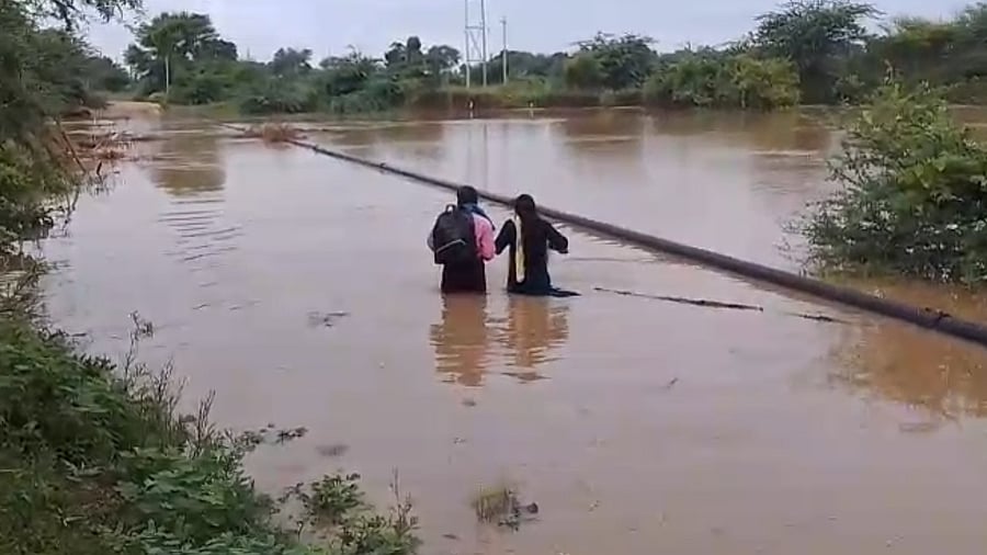 <div class="paragraphs"><p>A man and his daughter wade through the waist-high water on bridge across Kagina river in Sedam taluk, Kalaburagi district. The girl braved the flooded river to reach Sedam for her BA final exams. </p></div>