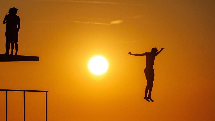 <div class="paragraphs"><p>A man jumps into the Adriatic sea during warm weather in Zadar, Croatia.</p></div>