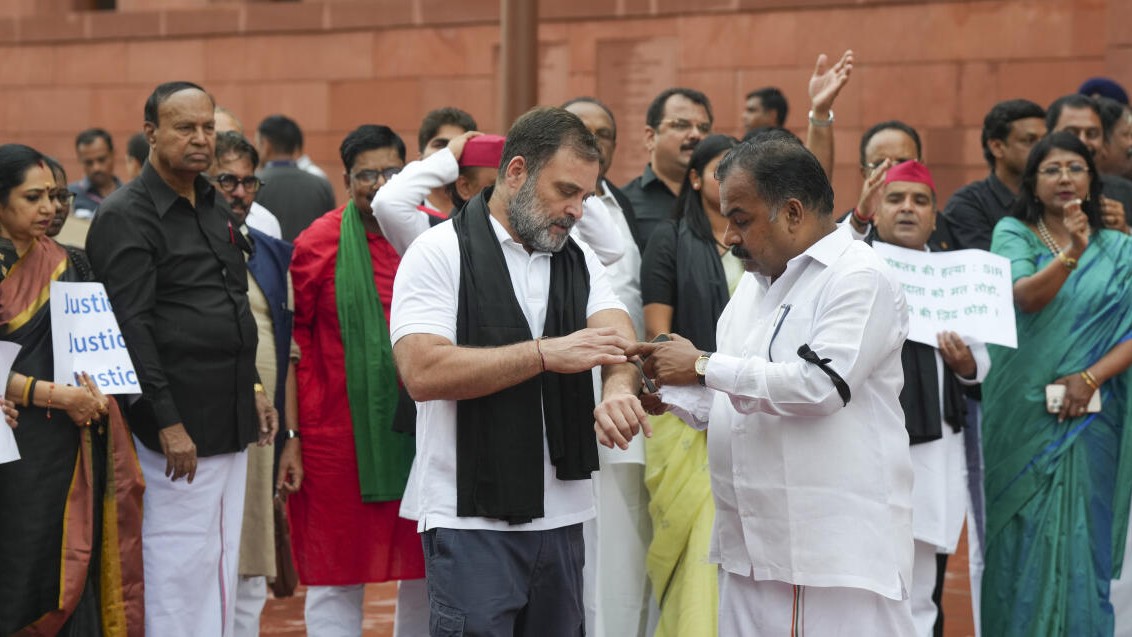 <div class="paragraphs"><p>Congress leader Rahul Gandhi being tied a black armband by party leader Manickam Tagore during a protest by INDIA bloc MPs against the Special Intensive Revision (SIR) of electoral rolls in poll-bound Bihar, during the Monsoon session of Parliament, in New Delhi.</p></div>