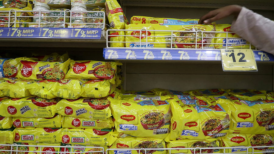<div class="paragraphs"><p>FILE PHOTO: A worker arranges packets of Nestle's Maggi noodles on a shelf inside a supermarket in Mumbai. </p></div>