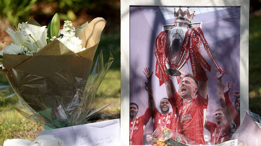 <div class="paragraphs"><p>A picture of Liverpool's Portuguese soccer player Diogo Jota stands next to flower tributes, after Jota died in a car crash near Zamora, Spain, outside Anfield Stadium in Liverpool.</p></div>