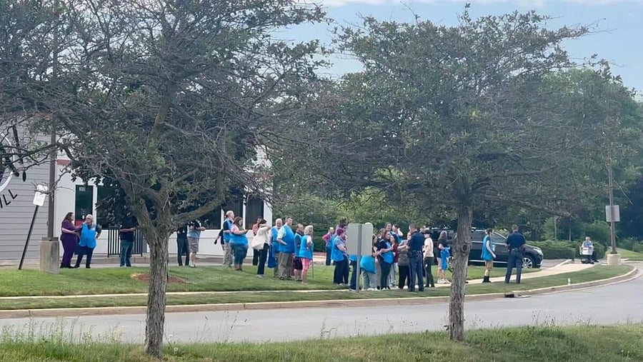 <div class="paragraphs"><p>Police officers speak to Walmart employees outside a Walmart store, where a stabbing incident occurred, in Traverse City, Michigan, US.</p></div>