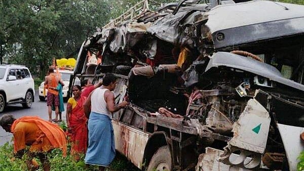 <div class="paragraphs"><p>People stand near the wreckage of a vehicle after a collision took place between a bus with passengers on board and a truck, loaded with cooking gas cylinders, in Jharkhand's Deoghar district.</p></div>