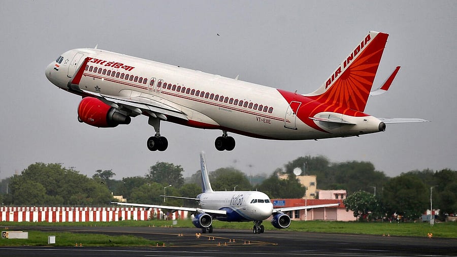 <div class="paragraphs"><p>An Air India Airbus craft takes off as an IndiGo Airlines aircraft waits for clearance at an Indian airport. </p></div>