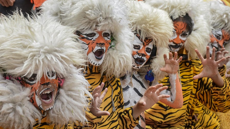 <div class="paragraphs"><p>Students dressed as tiger pose for photographs on International Tiger Day, in Bengaluru</p></div>