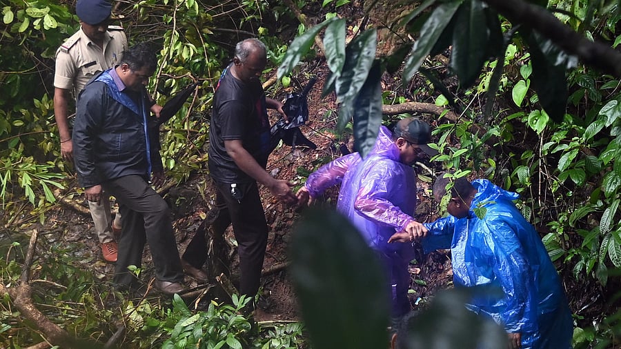 <div class="paragraphs"><p>SIT members being led into the forest to the sites on Wednesday.</p></div>