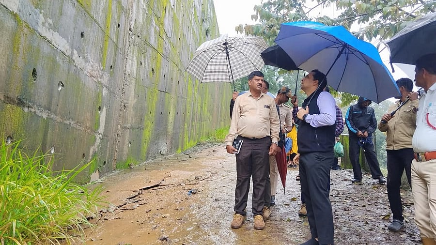 <div class="paragraphs"><p>Deputy Commissioner Venkat Raja on Thursday inspects the protective wall along the National Highway 275, which has developed cracks. </p></div>