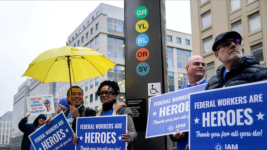 <div class="paragraphs"><p>Labor union members hold placards on the day of a rally in support of federal workers during a rush hour protest outside the L'Enfant Plaza Metro Station in Washington DC.</p></div>