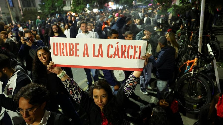 <div class="paragraphs"><p>A woman holds a banner that reads "Uribe goes to prison", as people gather in celebration after a judge found former Colombian President Alvaro Uribe guilty of abuse of process and bribery of a public official, in Bogota, Colombia July 28, 2025.</p></div>