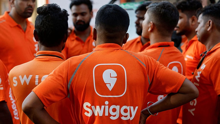 <div class="paragraphs"><p>Swiggy workers listen to a briefing.</p></div>