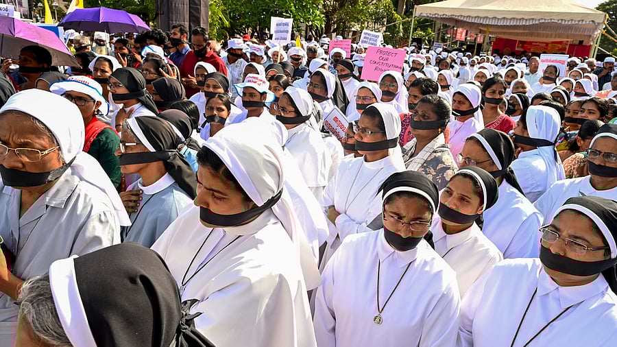 <div class="paragraphs"><p>Catholic Forum members with black cloth over their mouths hold a demonstration against the arrest of two Catholic nuns in BJP-ruled Chhattisgarh, in Thiruvananthapuram, Wednesday, July 30, 2025.</p></div>