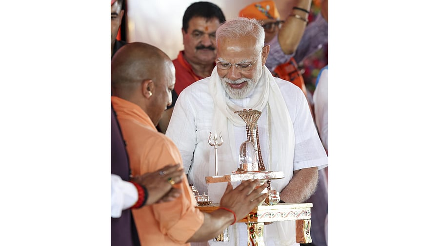 <div class="paragraphs"><p>Prime Minister Narendra Modi being felicitated by Uttar Pradesh Chief Minister Yogi Adityanath during a public meeting, in Varanasi. </p></div>