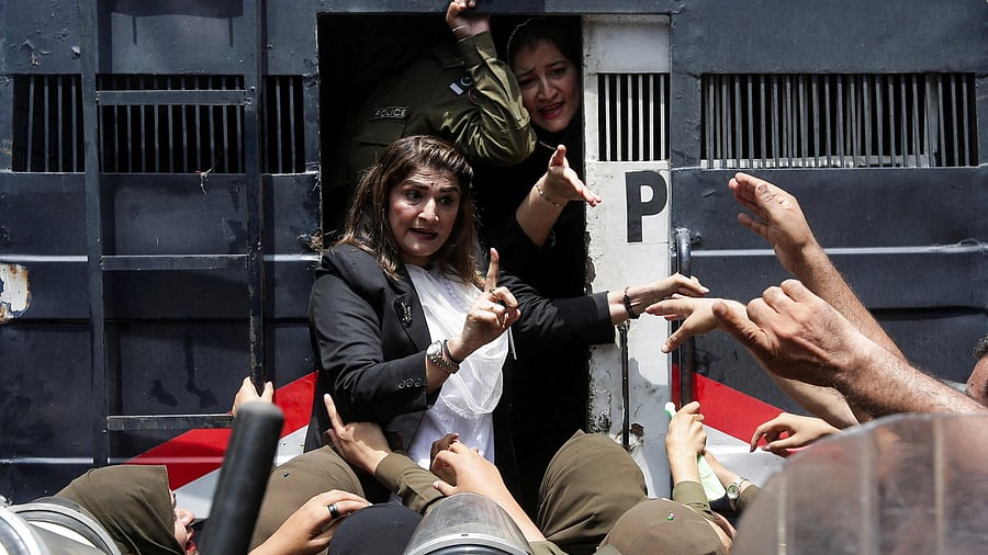 <div class="paragraphs"><p>A supporter of Pakistan's former Prime Minister Imran Khan and his party, Pakistan Tehreek-e-Insaf (PTI), reacts while being detained by police officers during a nationwide protest demanding Khan's release, on the second anniversary of his arrest, in Lahore, Pakistan, August 5, 2025. </p></div>
