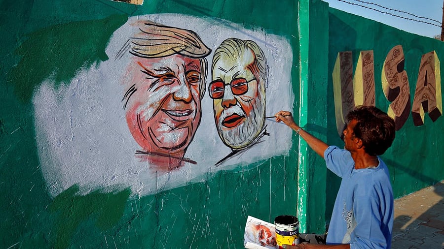 <div class="paragraphs"><p>A man applies finishing touches to paintings of U.S. President Trump and India's PM Modi, in Ahmedabad.</p></div>