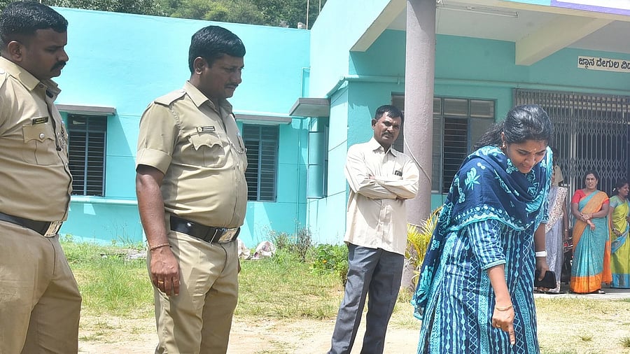 The Forest department officials look for pug marks of a leopard that had strayed into the school for speech and hearing impaired, run by Indian Red Cross Society, at Belagumba near Tumakuru on Monday.