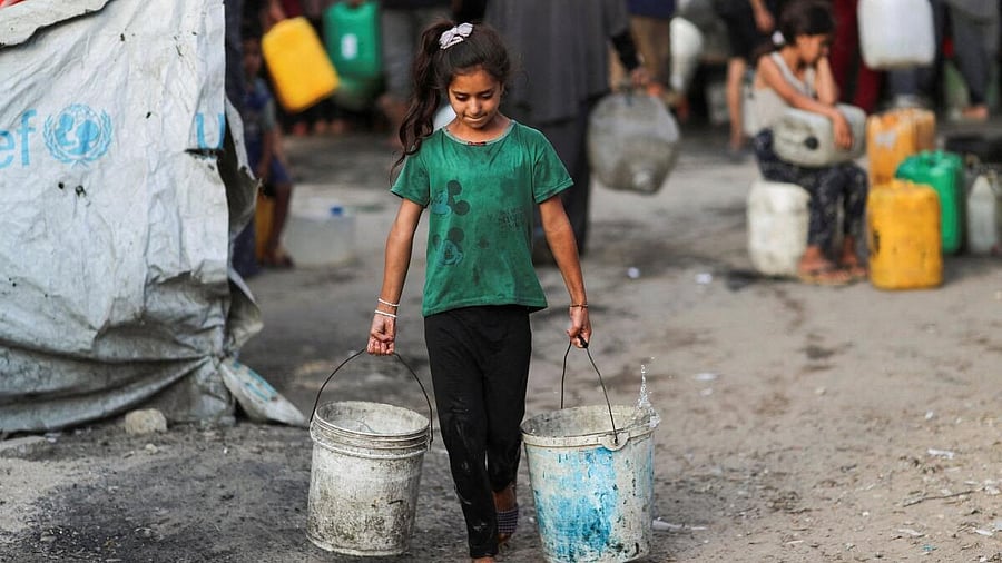 <div class="paragraphs"><p>A Palestinian girl carries buckets of water amid shortages, in Gaza City August 6, 2025.</p></div>