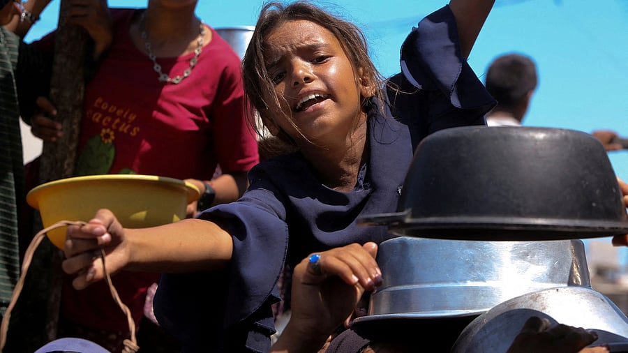 <div class="paragraphs"><p>File photo: A Palestinian girl gestures as she waits to receive food from a charity kitchen, amid a hunger crisis, in Khan Younis, southern Gaza Strip, August 4, 2025.</p></div>