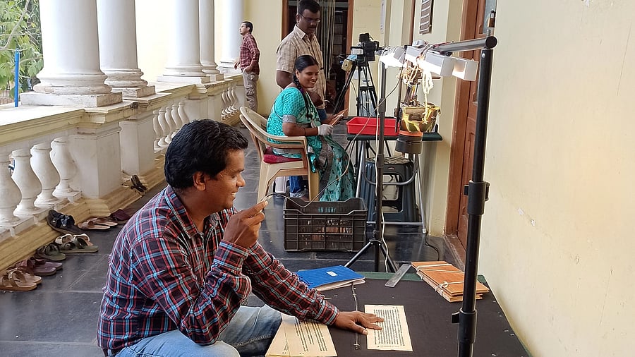 <div class="paragraphs"><p>A worker scans manuscripts for digitising them at the Oriental Research Institute in Mysuru.&nbsp; &nbsp;</p></div>