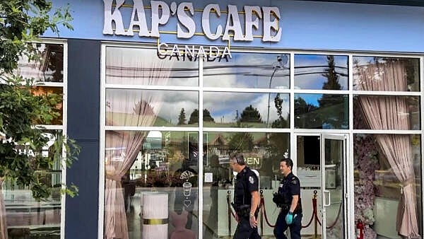 <div class="paragraphs"><p>Police personnel investigate after shots were fired at Kap's Cafe, owned by Indian comdian Kapil Sharma, in Surrey, Canada, Friday, Aug. 8, 2025.</p></div>