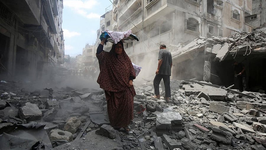 <div class="paragraphs"><p>Palestinians inspect the site of a morning Israeli strike on a house, in Gaza City, August 8, 2025.</p></div>