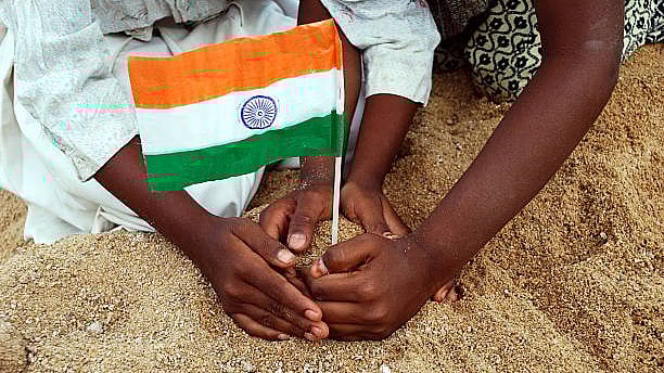 <div class="paragraphs"><p>Representative image of people placing Indian flag into soil.</p></div>